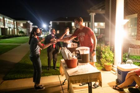 Students fuel up at the apartment of Ben Bredow, residence director of the male quads, during Progressive Snacking.  - Photo by Kristi McMurry Woody