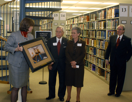 Provost Carla Sanderson presents Bob (’48) and Mary Ruth ('56) Hundley a photo of The Hundley Center for Academic Enrichment during a Homecoming dedication ceremony. - Photo by Morris Abernathy