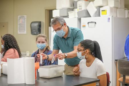 William Thierfelder, associate professor of biology, hands out materials for an assignment in Immunology. - Photo by Kristi McMurry Woody