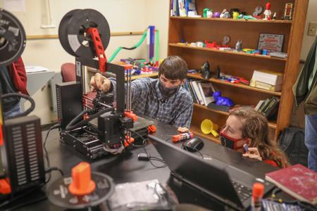 Georg Pingen, professor of engineering, works with art students to make 3d printed components for their sculpture projects. - Photo by Kristi McMurry Woody