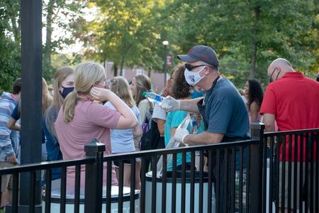 Todd Brady (right), vice president for university ministries, serves ice cream to new students during Welcome Week. - Photo by Joey Echeverria