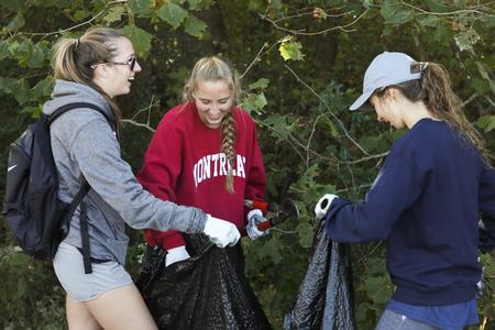 Students help clean up the area around the Union Trails during Campus and Community Day. - Photo by Sarah Palmer Goff