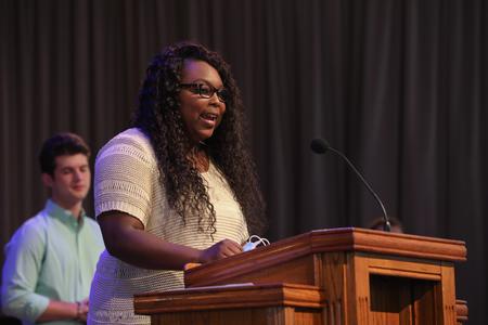 Takiya Britton, political science major, reads scripture in chapel. - Photo by Sarah Palmer Goff