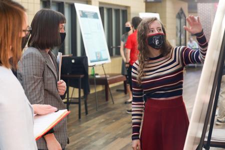 Ruth Duncan, studio art graduate, presents her senior project during Fall Poster Sessions.  - Photo by Sarah Palmer Goff
