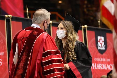 Lauren Blodgett, business administration graduation, receives her diploma during Fall Graduation. - Photo by Kristi McMurry Woody