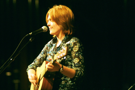 Alice Calvery plays guitar for freshmen classmates in the Variety Show during New Student Orientation 2002. - Photo by Kristen Hiller