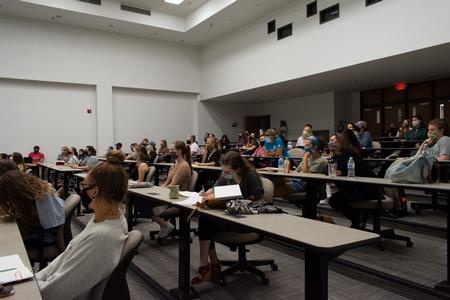 Students take notes and listen to Sandra Bowden's artist lecture in Harvey Auditorium. - Photo by Naomi Mengel