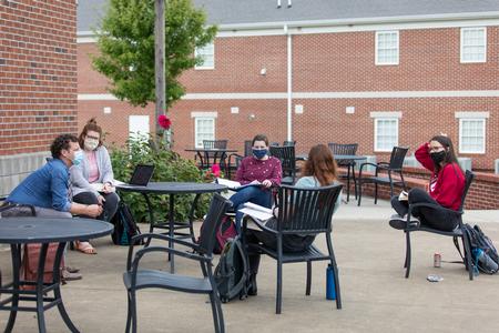 Phillip Ryan, professor of language, teaches a class outside of Barefoots Joe.  - Photo by Kristi McMurry Woody