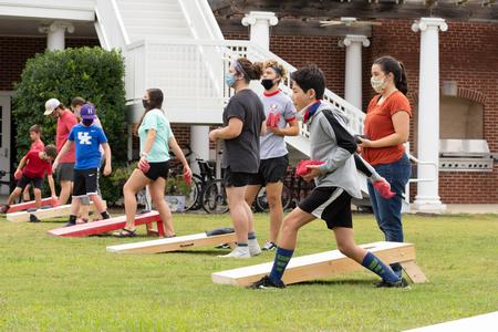 Students and their families enjoy a cornhole tournament during Family Weekend. - Photo by Naomi Mengel