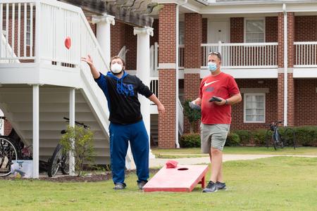 Students and their families enjoy a cornhole tournament during Family Weekend. - Photo by Naomi Mengel