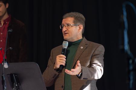 John Kinchen, chair of the music department, speaks during A Thankful Christmas. - Photo by Naomi Mengel