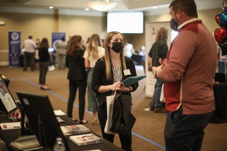 Reegan Cadonau, interdisciplinary studies major, talks with recruiters during the Education Expo. - Photo by Kristi McMurry Woody