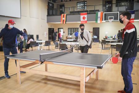 Spring Break GO Trip students gather for a dinner and games with international students. - Photo by Kristi McMurry Woody
