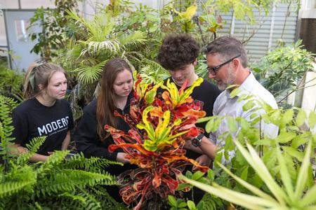 Michael Schiebout (right), associate professor of biology, shows students around the greenhouse in White Hall. - Photo by Kristi McMurry Woody