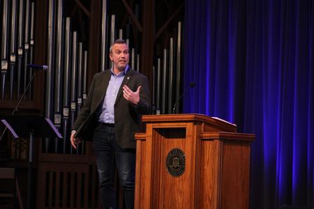 Matt Bowman, director for graduate admissions and recruitment in the College of Education, speaks in chapel. - Photo by Abigail Aspinwall
