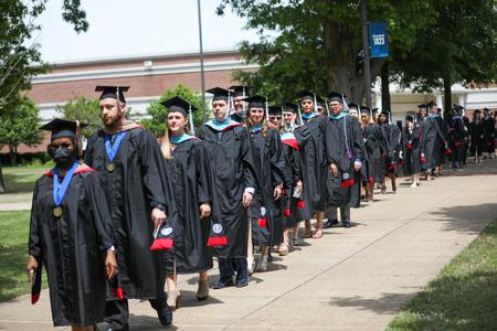 Graduates make their way to the Great Lawn for spring commencement services.  - Photo by Kristi McMurry Woody
