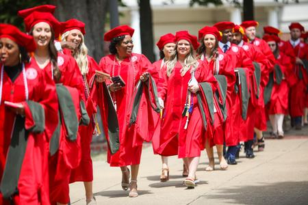 Graduates make their way to the Great Lawn to begin spring commencement. - Photo by Kristi McMurry Woody