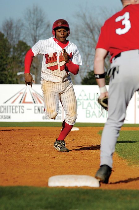 Patrick Williams (23) attempts to take third base in a game versus William Carey College. - Photo by Kathleen Murray