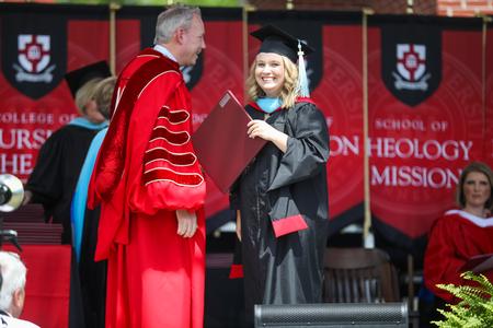 Anna Clare Derrick, master of urban education graduate, receives her diploma during spring commencement. - Photo by Kristi McMurry Woody
