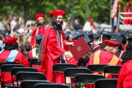 Graduates make their way back to their seats after receiving their diplomas during spring graduation. - Photo by Kristi McMurry Woody