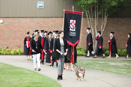 Buster processes with graduates to the Great Lawn to begin spring commencement. - Photo by Kristi McMurry Woody