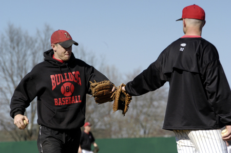 Seniors Jason Johnson (left) and Adams Yates (right) exchange glove taps during prior to a Union game. - Photo by Kathleen Murray