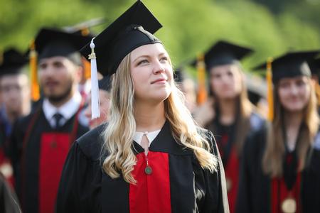 Callie Teague, public relations graduate, looks up to the stage as her fellow graduates find their seats to begin spring commencement. - Photo by Kristi McMurry Woody