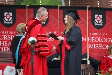 Sara Beth Conley, public relations graduate, receives her diploma during spring commencement. - Photo by Kristi McMurry Woody