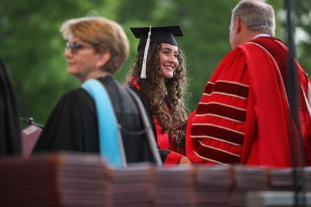 Naomi Mengel, journalism graduate, receives her diploma during spring commencement. - Photo by Kristi McMurry Woody