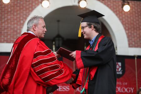 Darius Mullin, biology graduate, receives his diploma during spring commencement. - Photo by Kristi McMurry Woody