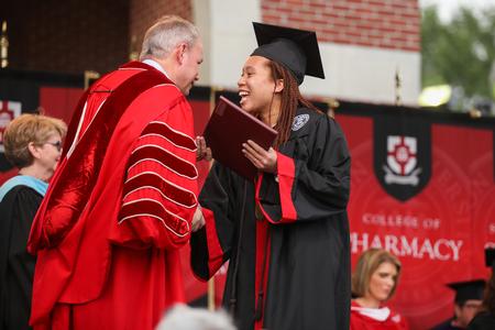 Jaya Wilson, sport management graduate, receives her diploma during spring commencement. - Photo by Kristi McMurry Woody