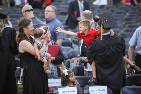 Graduates celebrate with friends and family at the conclusion of spring commencement. - Photo by Kristi McMurry Woody