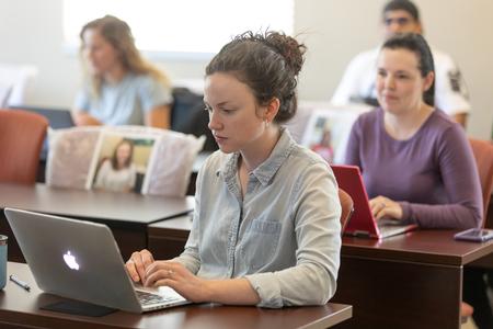 Students on the Hendersonville campus take notes in class.  - Photo by Kristi McMurry Woody