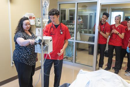 Allison Davis, professor of nursing, works with students in the Hendersonville simulation labs. - Photo by Kristi McMurry Woody