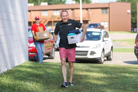 Dub Oliver, president of the university, helps during Move-in Day. - Photo by Kristi McMurry Woody