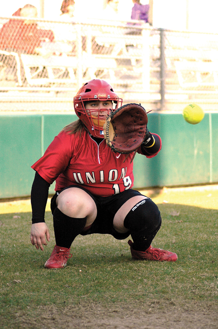 Kristen Kolter warms up the Union pitcher prior to the start of a game. - Photo by Amanda Herron