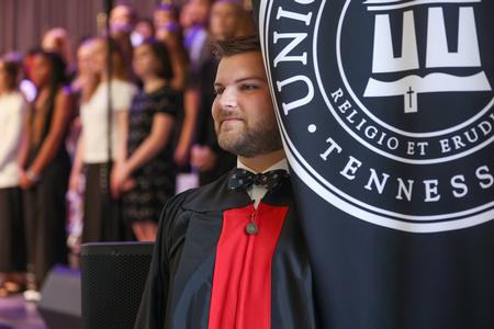 Grant Gammon, SGA president, acts as banner carrier during Convocation. - Photo by Kristi McMurry Woody