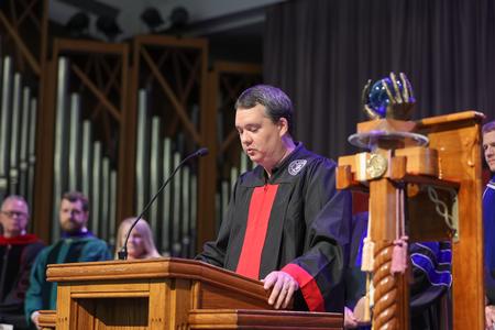 Brad Seaton, staff member of the year, opens Convocation with scripture. - Photo by Kristi McMurry Woody