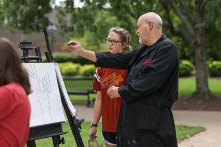 Students in Drawing 1 do a drawing exercise outside during class. - Photo by Kristi McMurry Woody