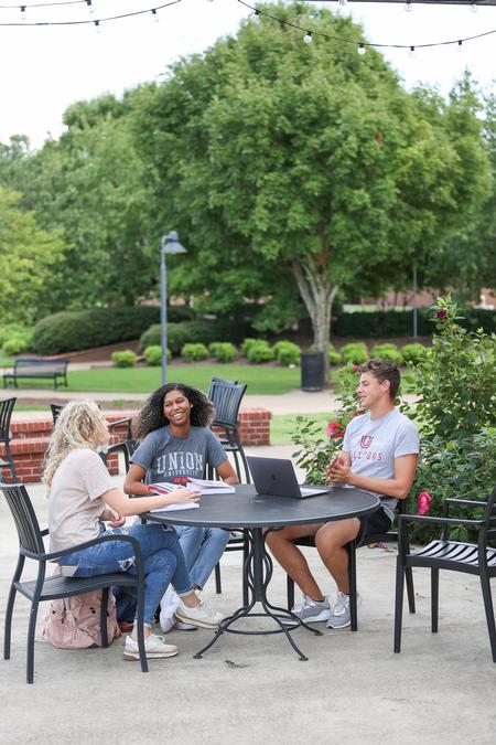 Maddie Steele, Gabby Defreitis and Sean Otto sit outside Barefoots Joe on a nice fall day. - Photo by Kristi McMurry Woody