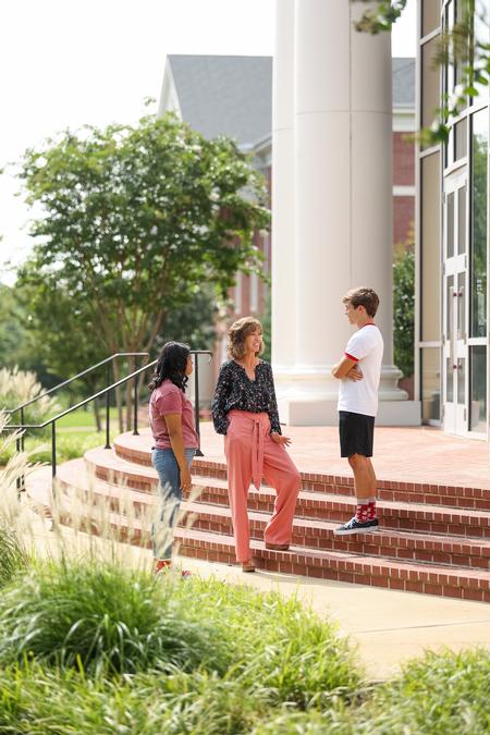 Karen Miller (center), director for accounting & professor of accounting, chats with students outside the Logos. - Photo by Kristi McMurry Woody