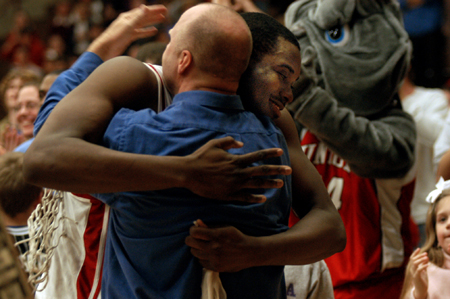 Sophomore center Pierry Valmera and head coach Ralph Turner exchange hugs after Union's TranSouth Conference Tournament Championship. - Photo by Jonathan Blair