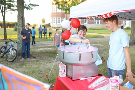 Members of Student Activities Council make cotton candy for guests of Family Weekend Union Night.  - Photo by Kristi McMurry Woody