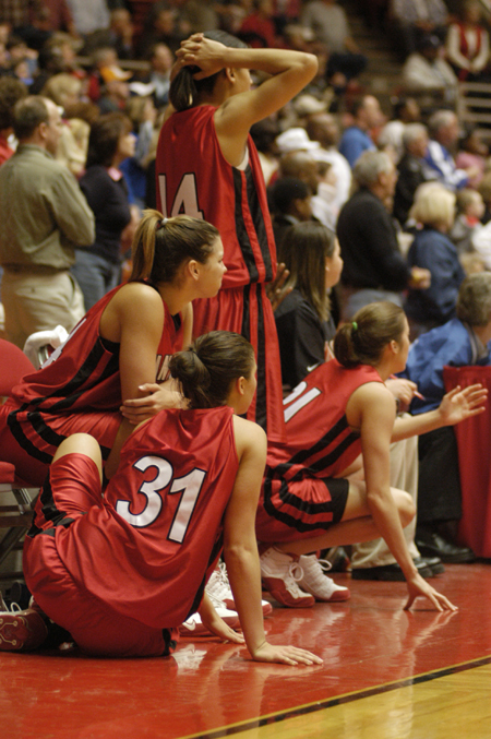 Union Lady Bulldogs, Merideth Richardson (31), Molly York (sitting), Tiffany Fisher (standing), and Peggy McCain (21), watch intently during the final seconds of regulation during Union's second round game in the NAIA National Tournament.  Union defeated North Georgia in this game 83-75 in overtime. - Photo by Kristen Nicole Sayres