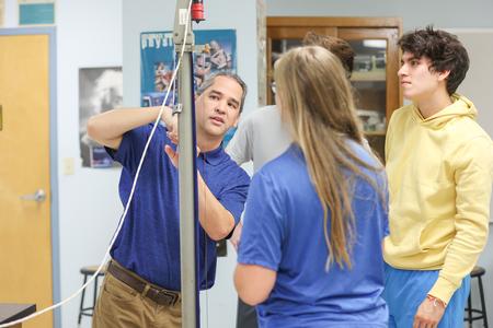 Fonsie Guilaran, professor of physics, works on a lab experiment with his class. - Photo by Kristi McMurry Woody