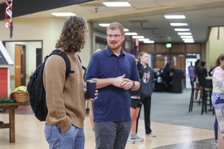 Joe Ball, director for discipleship and ministry, grabs breakfast with a student in the cafeteria. - Photo by Kristi McMurry Woody