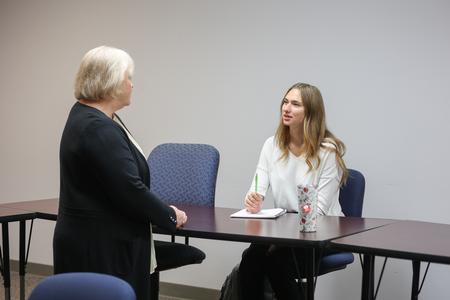 Melessia Mathis, assistant professor of education, talks with Treava Schmitter-Schrier, special education major, before class. - Photo by Kristi McMurry Woody