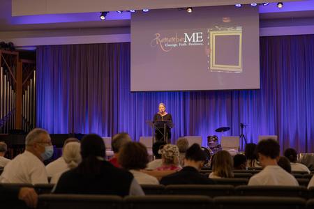 Nite Mehr, director for MSW programs and professor of social work, welcomes guests of the Remember Me Walk. - Photo by Cade Smith