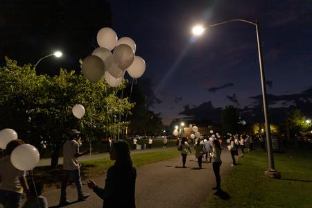 Participants in the Remember Me Walk for homicide survivors walk in memory of their lost loved ones outside the chapel. - Photo by Cade Smith