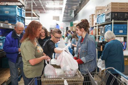 Union students join with other volunteers at RIFA to pack food for community members during Campus & Community Day. - Photo by Kristi McMurry Woody